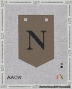 A taped needlepoint canvas with the design: Banner 18 mesh count Pointed N Black on Brown.