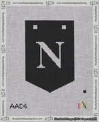 A taped needlepoint canvas with the design: Banner 18 mesh count Pointed N White on Black.
