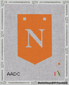 A taped needlepoint canvas with the design: Banner 18 mesh count Pointed N White on Orange.
