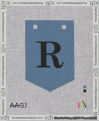 A taped needlepoint canvas with the design: Banner 18 mesh count Pointed R Black on Blue.