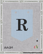 A taped needlepoint canvas with the design: Banner 18 mesh count Pointed R Black on Light Blue.