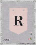 A taped needlepoint canvas with the design: Banner 18 mesh count Pointed R Black on Pink.