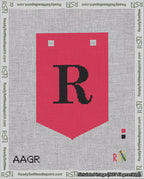 A taped needlepoint canvas with the design: Banner 18 mesh count Pointed R Black on Red.