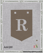 A taped needlepoint canvas with the design: Banner 18 mesh count Pointed R White on Brown.
