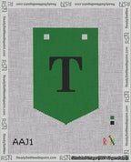 A taped needlepoint canvas with the design: Banner 18 mesh count Pointed T Black on Green.