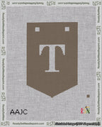 A taped needlepoint canvas with the design: Banner 18 mesh count Pointed T White on Brown.