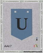 A taped needlepoint canvas with the design: Banner 18 mesh count Pointed U Black on Blue.