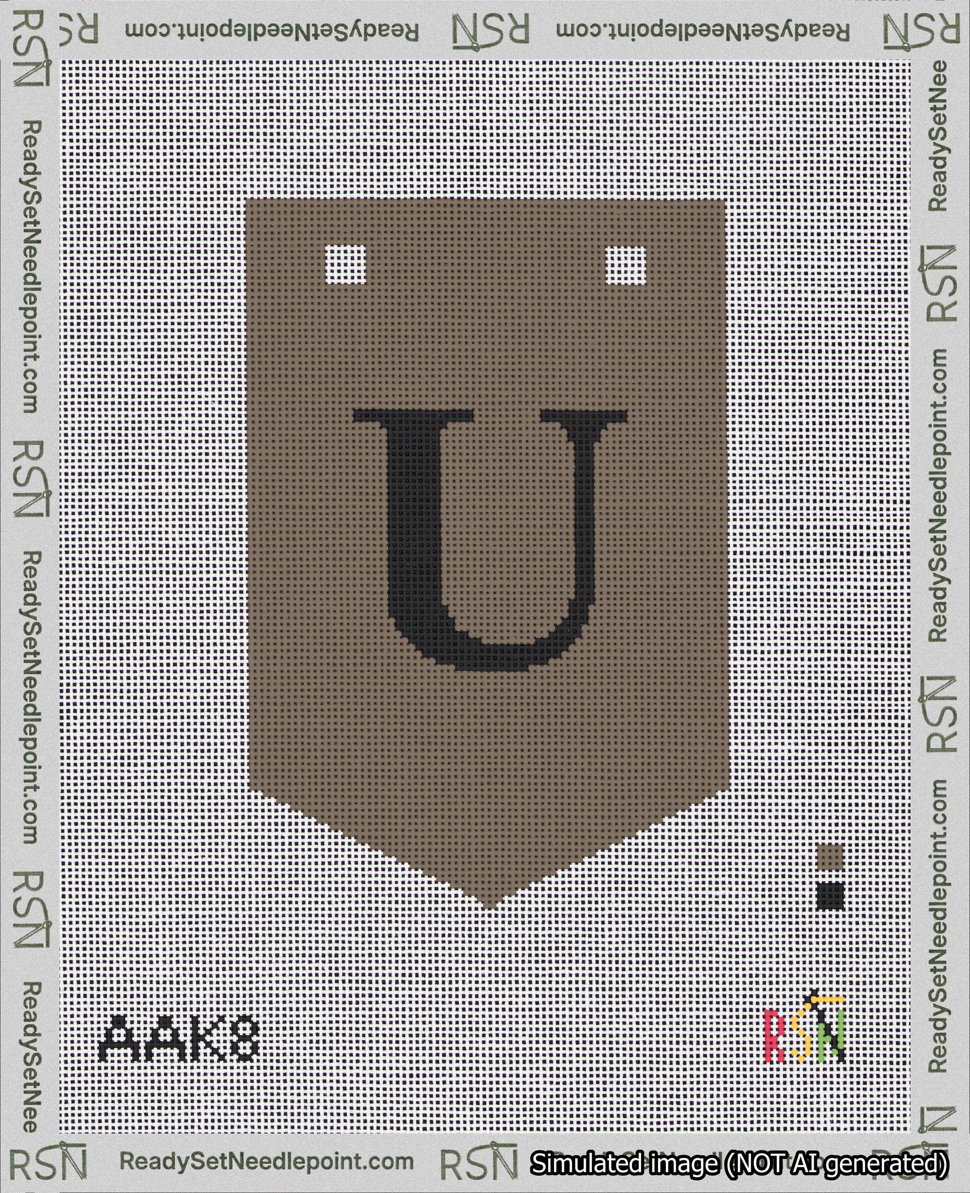 A taped needlepoint canvas with the design: Banner 18 mesh count Pointed U Black on Brown.