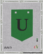 A taped needlepoint canvas with the design: Banner 18 mesh count Pointed U Black on Green.