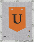 A taped needlepoint canvas with the design: Banner 18 mesh count Pointed U Black on Orange.