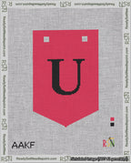 A taped needlepoint canvas with the design: Banner 18 mesh count Pointed U Black on Red.