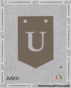 A taped needlepoint canvas with the design: Banner 18 mesh count Pointed U White on Brown.