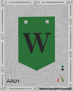 A taped needlepoint canvas with the design: Banner 18 mesh count Pointed W Black on Green.