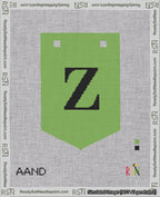 A taped needlepoint canvas with the design: Banner 18 mesh count Pointed Z Black on Light Green.