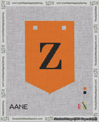 A taped needlepoint canvas with the design: Banner 18 mesh count Pointed Z Black on Orange.