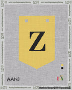 A taped needlepoint canvas with the design: Banner 18 mesh count Pointed Z Black on Yellow.