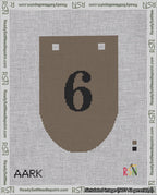 A taped needlepoint canvas with the design: Banner 18 mesh count Rounded 6 Black on Brown.