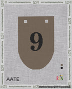A taped needlepoint canvas with the design: Banner 18 mesh count Rounded 9 Black on Brown.