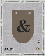 A taped needlepoint canvas with the design: Banner 18 mesh count Rounded Ampersand Black on Brown.