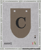 A taped needlepoint canvas with the design: Banner 18 mesh count Rounded C Black on Brown.