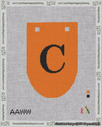 A taped needlepoint canvas with the design: Banner 18 mesh count Rounded C Black on Orange.