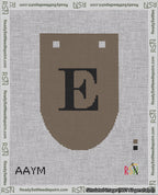 A taped needlepoint canvas with the design: Banner 18 mesh count Rounded E Black on Brown.