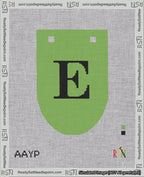 A taped needlepoint canvas with the design: Banner 18 mesh count Rounded E Black on Light Green.