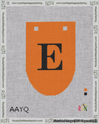 A taped needlepoint canvas with the design: Banner 18 mesh count Rounded E Black on Orange.