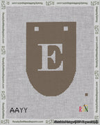 A taped needlepoint canvas with the design: Banner 18 mesh count Rounded E White on Brown.