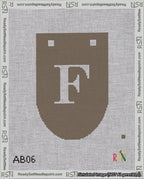 A taped needlepoint canvas with the design: Banner 18 mesh count Rounded F White on Brown.