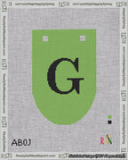 A taped needlepoint canvas with the design: Banner 18 mesh count Rounded G Black on Light Green.