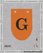 A taped needlepoint canvas with the design: Banner 18 mesh count Rounded G Black on Orange.