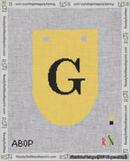 A taped needlepoint canvas with the design: Banner 18 mesh count Rounded G Black on Yellow.