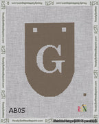 A taped needlepoint canvas with the design: Banner 18 mesh count Rounded G White on Brown.