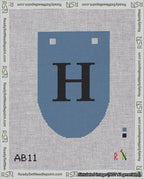 A taped needlepoint canvas with the design: Banner 18 mesh count Rounded H Black on Blue.