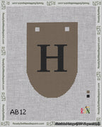 A taped needlepoint canvas with the design: Banner 18 mesh count Rounded H Black on Brown.