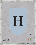 A taped needlepoint canvas with the design: Banner 18 mesh count Rounded H Black on Light Blue.