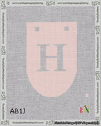 A taped needlepoint canvas with the design: Banner 18 mesh count Rounded H White on Pink.