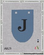 A taped needlepoint canvas with the design: Banner 18 mesh count Rounded J Black on Blue.
