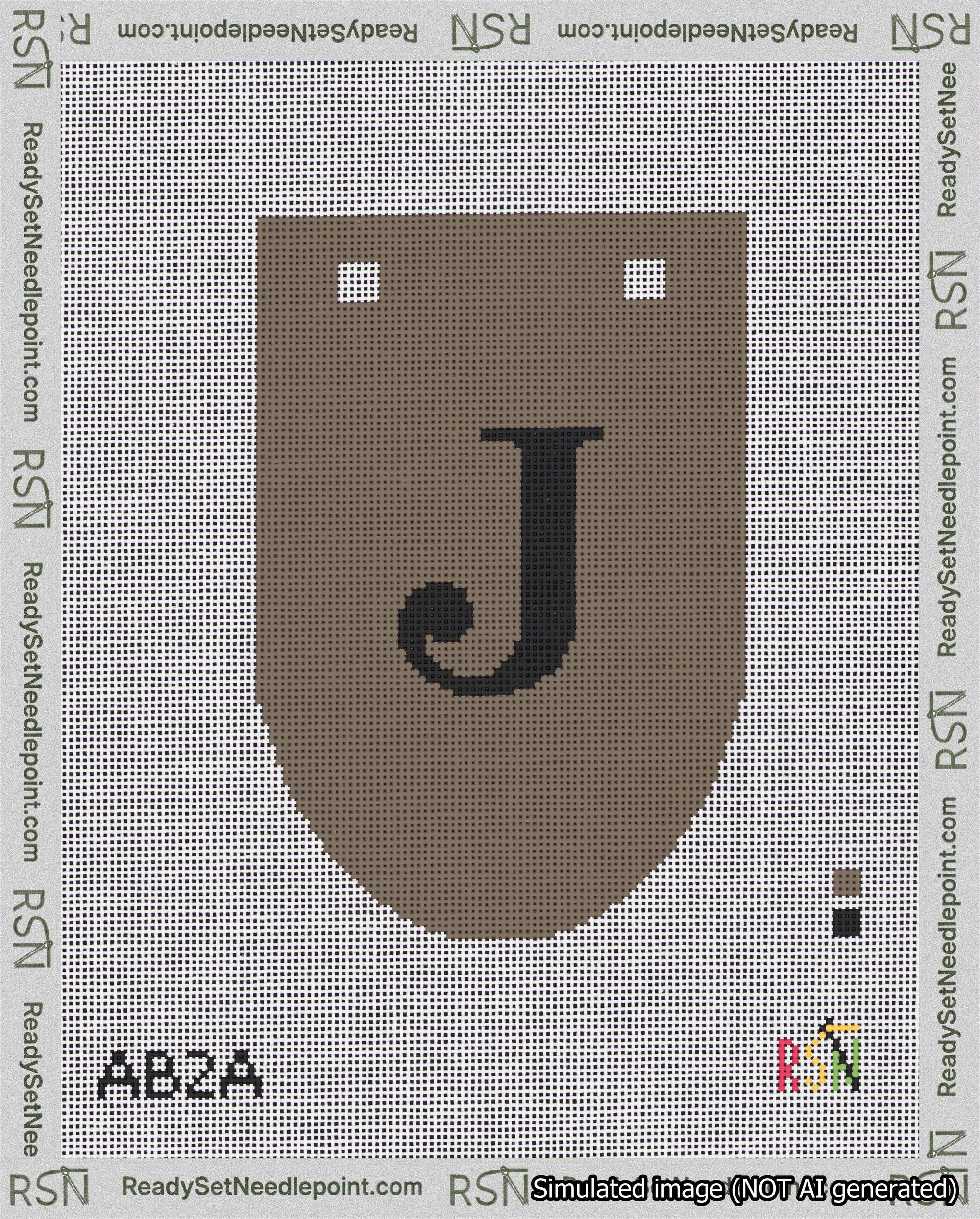 A taped needlepoint canvas with the design: Banner 18 mesh count Rounded J Black on Brown.
