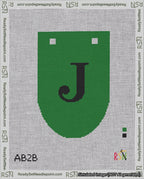 A taped needlepoint canvas with the design: Banner 18 mesh count Rounded J Black on Green.