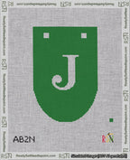 A taped needlepoint canvas with the design: Banner 18 mesh count Rounded J White on Green.