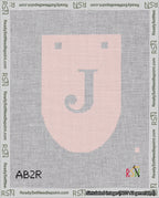 A taped needlepoint canvas with the design: Banner 18 mesh count Rounded J White on Pink.