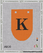 A taped needlepoint canvas with the design: Banner 18 mesh count Rounded K Black on Orange.
