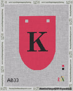 A taped needlepoint canvas with the design: Banner 18 mesh count Rounded K Black on Red.