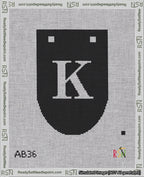 A taped needlepoint canvas with the design: Banner 18 mesh count Rounded K White on Black.