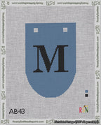 A taped needlepoint canvas with the design: Banner 18 mesh count Rounded M Black on Blue.
