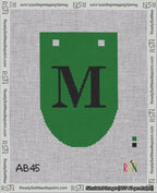 A taped needlepoint canvas with the design: Banner 18 mesh count Rounded M Black on Green.