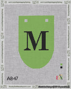 A taped needlepoint canvas with the design: Banner 18 mesh count Rounded M Black on Light Green.