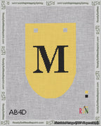 A taped needlepoint canvas with the design: Banner 18 mesh count Rounded M Black on Yellow.